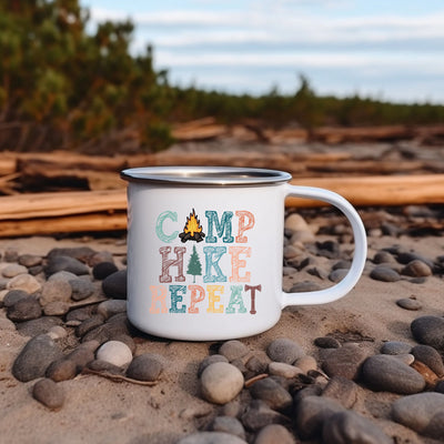 a camp mug sitting on a rocky beach