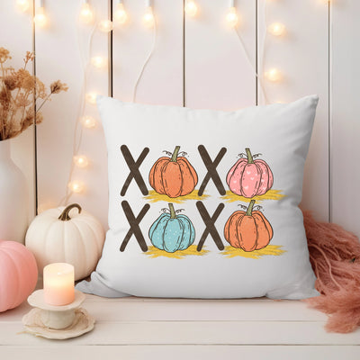 a white pillow with a picture of pumpkins on it