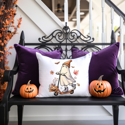 a bench with two pumpkins and a pillow on it