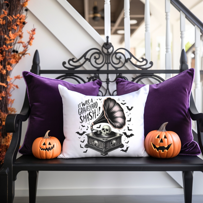 a bench with two pumpkins and a pillow on it