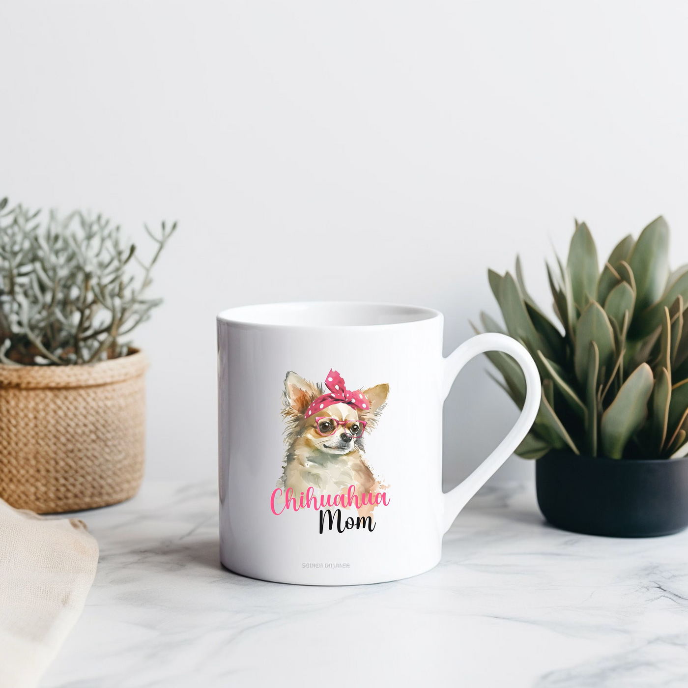 a mug with a chihuahua on it sitting next to a potted plant