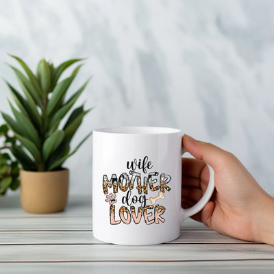 a person holding a white coffee mug with the words wife dog lover on it