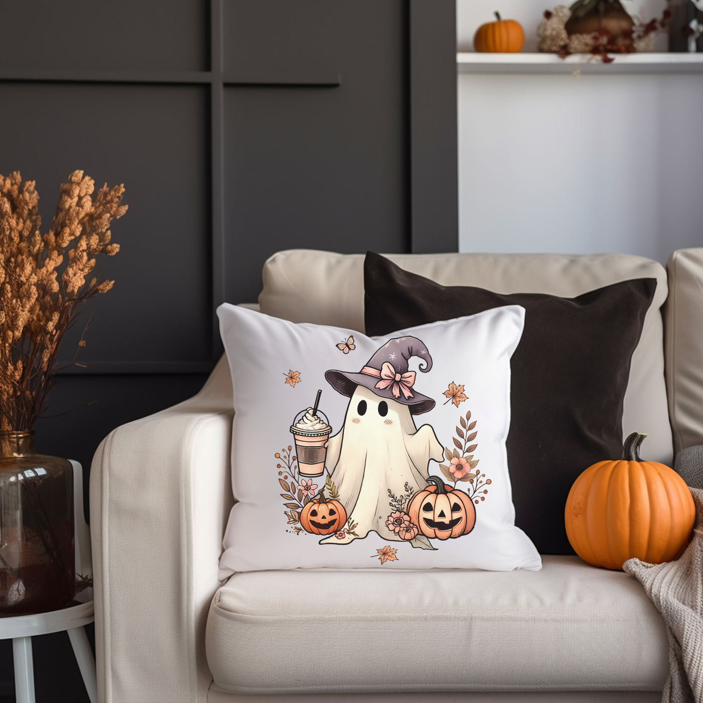 a white couch with a halloween pillow on it