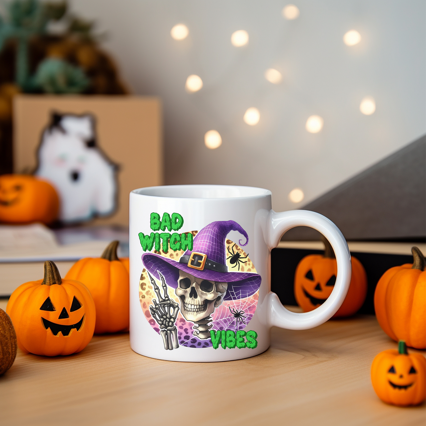 a white coffee mug with a skeleton wearing a witches hat