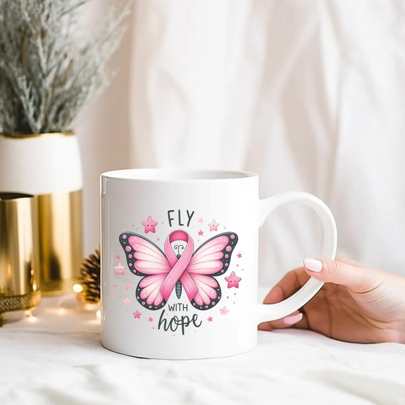 a person holding a coffee mug with a pink butterfly on it