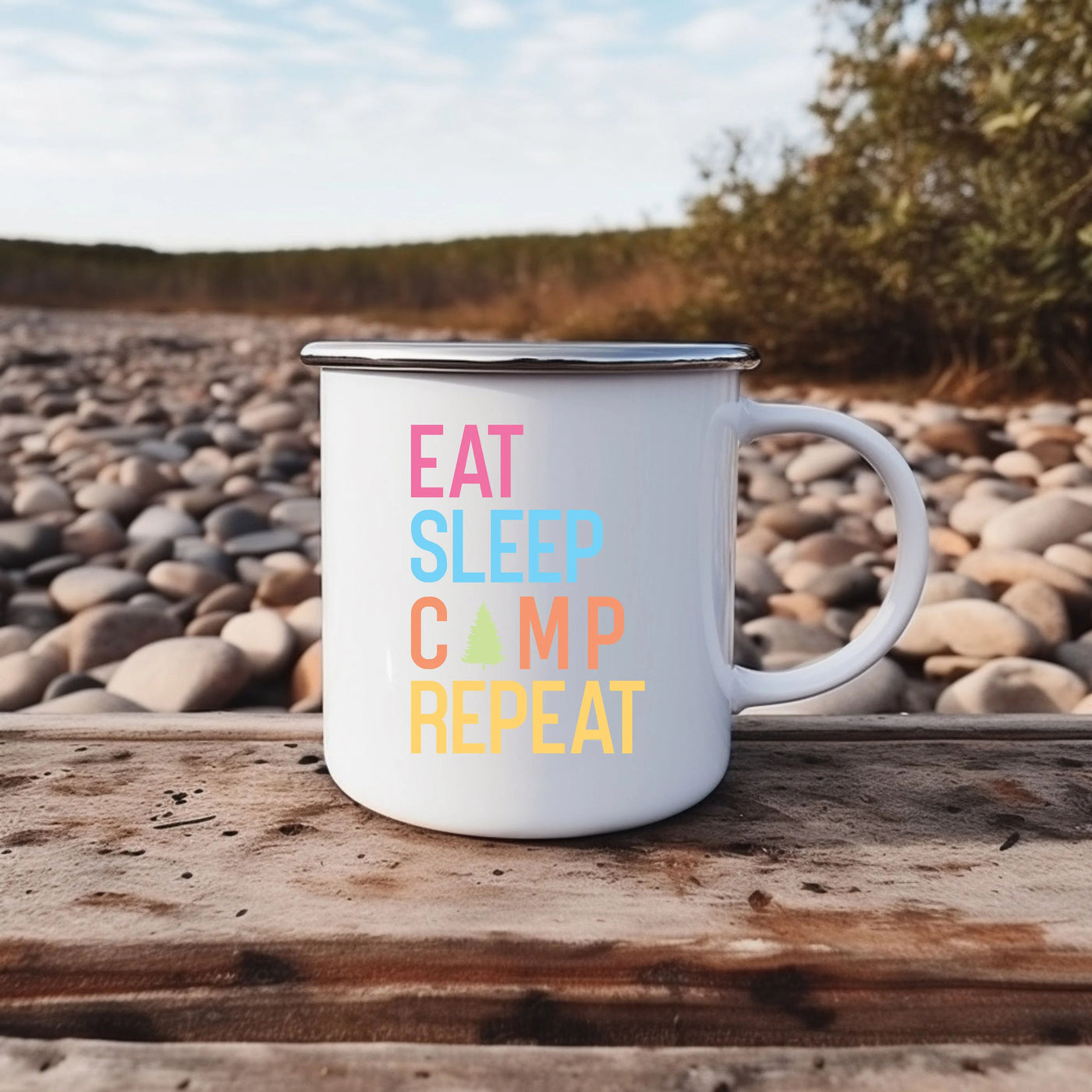 a white camp mug sitting on top of a wooden table