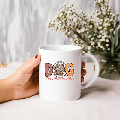 a person holding a coffee mug with a dog on it