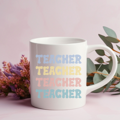 a white coffee mug with the words teacher on it