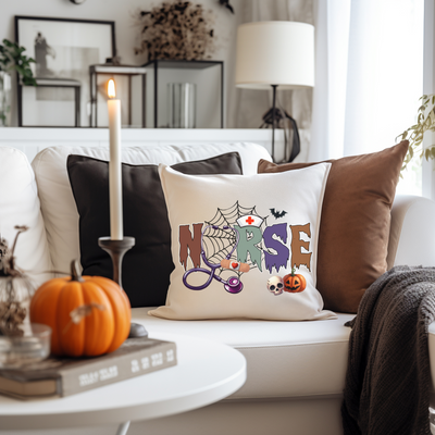 a white couch with a halloween pillow on it