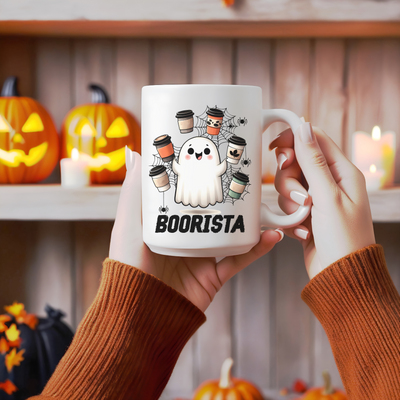 a person holding a coffee mug with a ghost on it