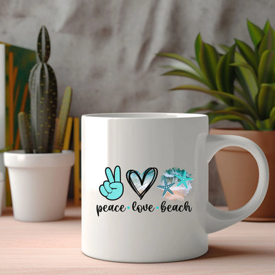 a coffee mug with peace love beach written on it