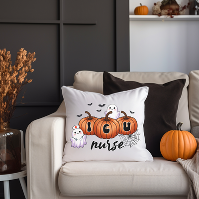 a white couch with a halloween pillow on it