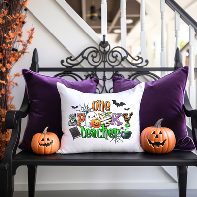 a bench with two pumpkins and a pillow on it