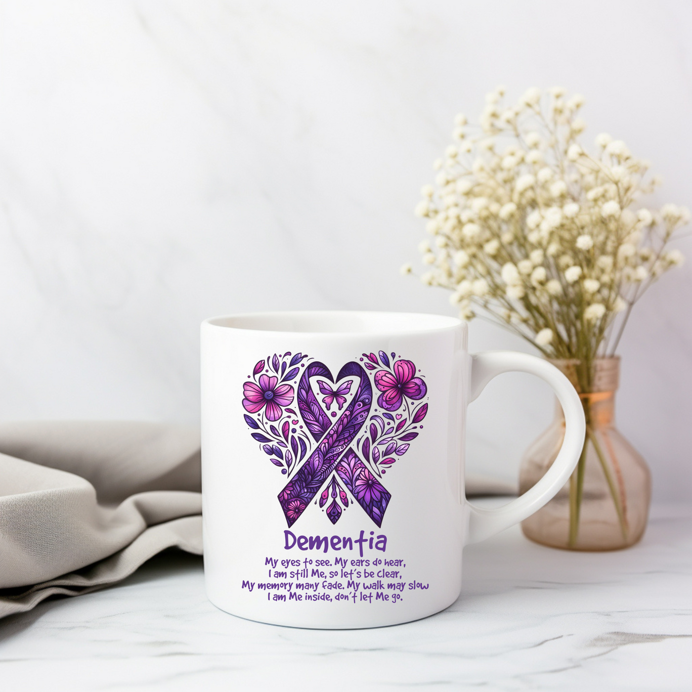 a white coffee mug with a purple ribbon on it